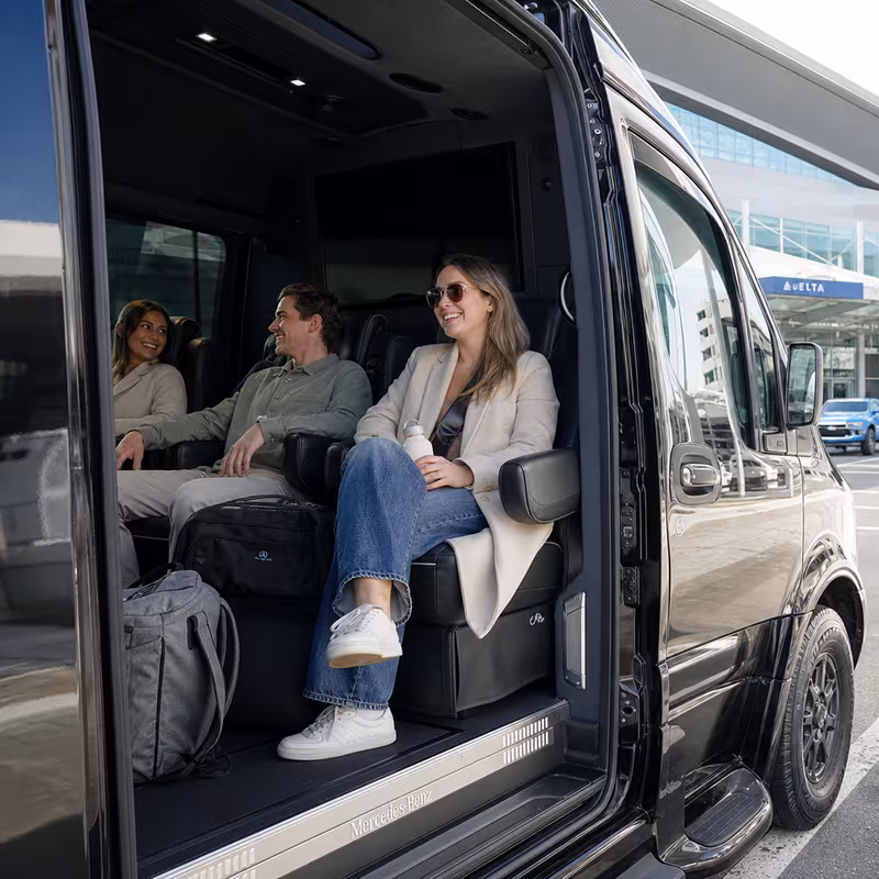 Passengers loading luggage while boarding an Boston group shuttle