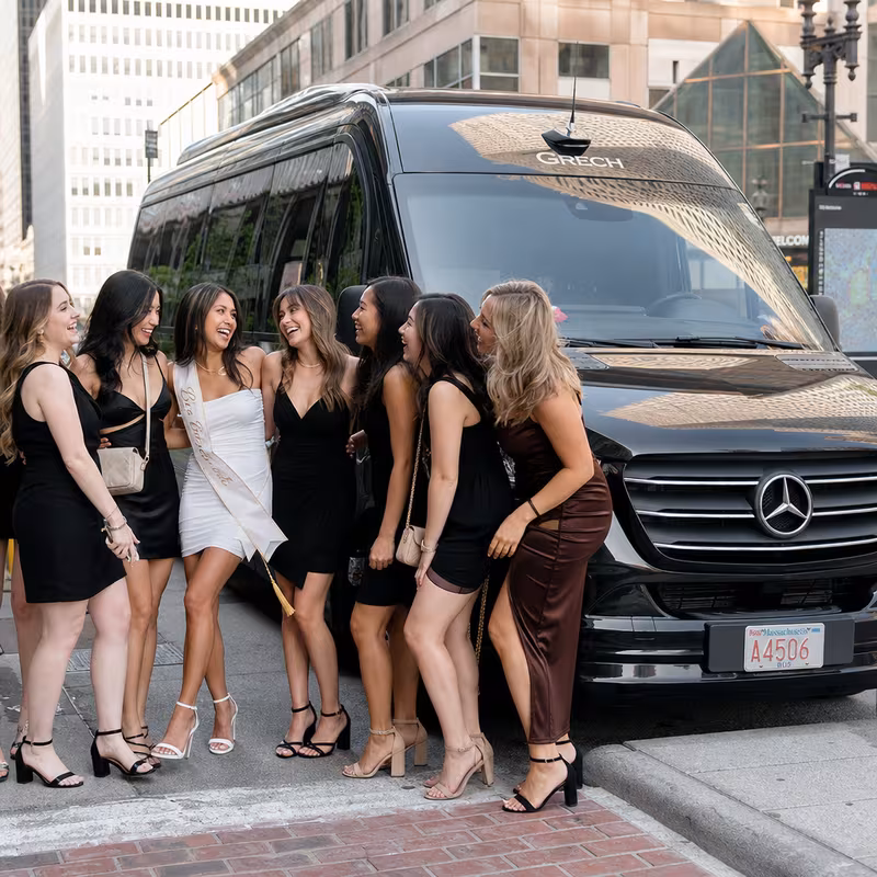 Group boarding a white charter bus for Bachelor & Bachelorette Transportation transportation in Boston
