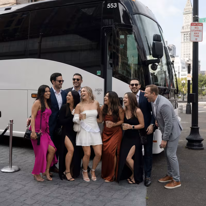 Passengers loading luggage while boarding an Boston group shuttle