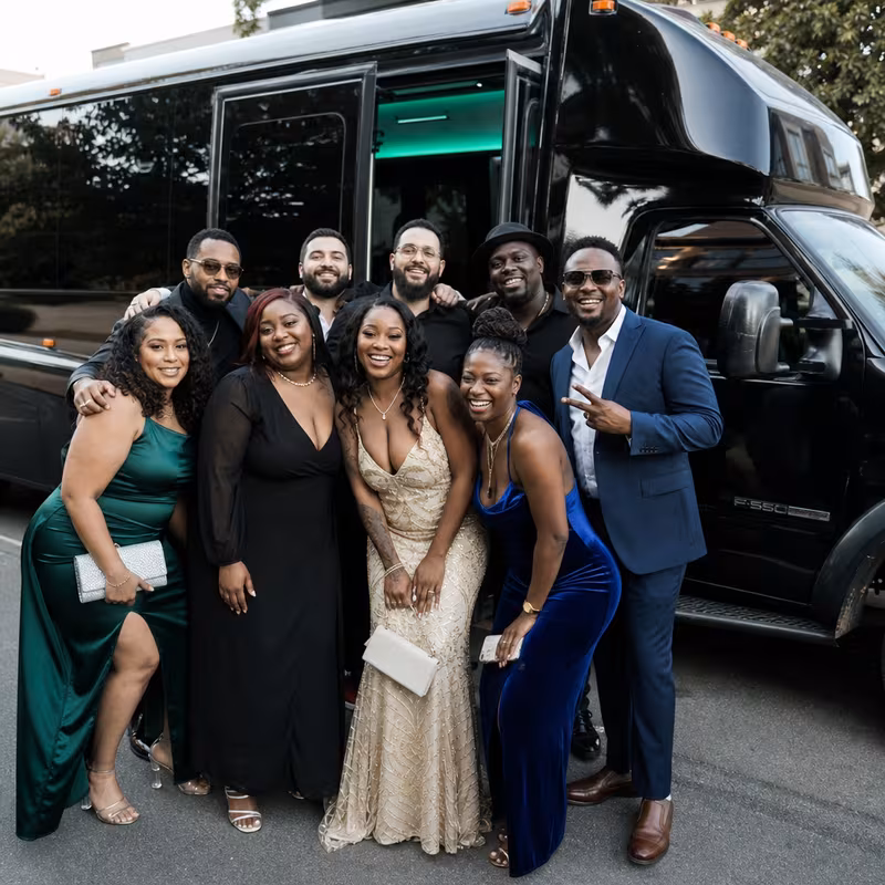 Group boarding a white charter bus for Birthday Transportation transportation in Boston