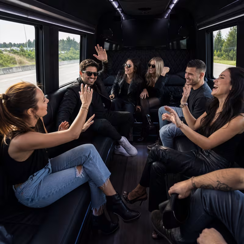 Group boarding a white charter bus for Concert Transportation transportation in Boston