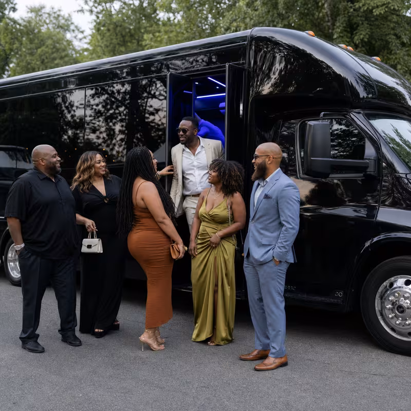 Passengers loading luggage while boarding an Boston group shuttle