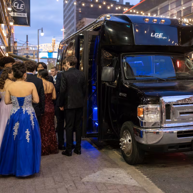 Passengers loading luggage while boarding an Boston group shuttle