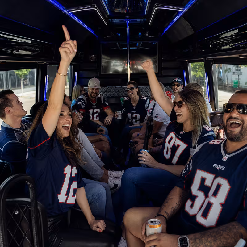Group boarding a white charter bus for Sporting Event Transportation transportation in Boston