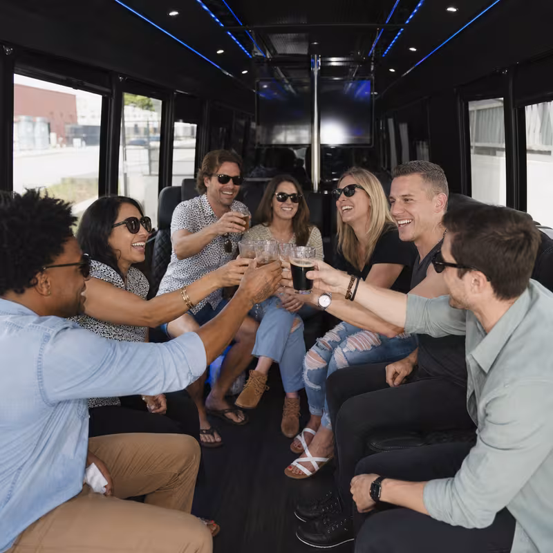 Group boarding a white charter bus for Winery & Brewery Tour Transportation transportation in Boston