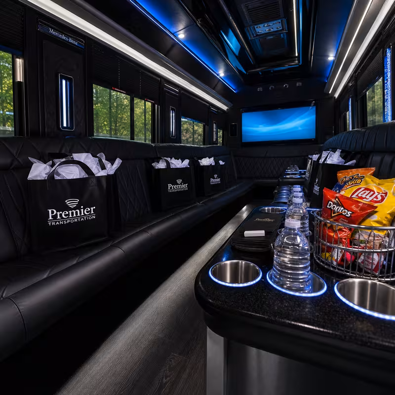 Party bus interior with wraparound leather seating and LED lighting in Boston